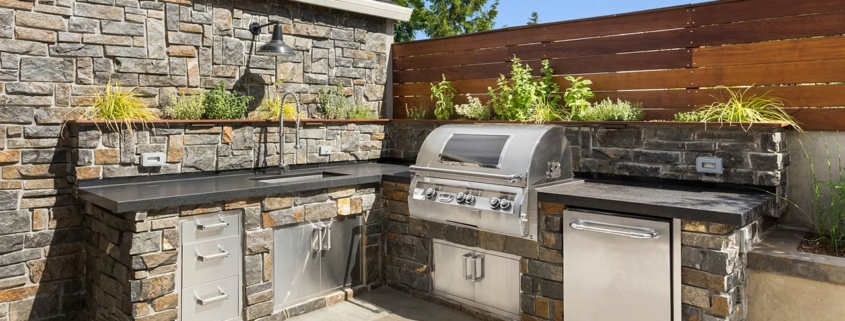 Backyard hardscape entertainment area with built-in kitchen