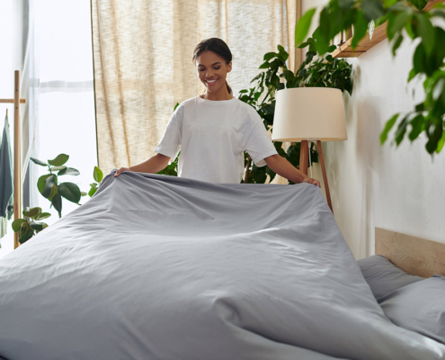 Young african american making a bed stock photo